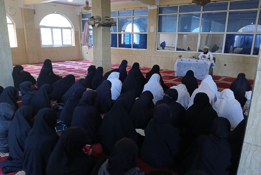 Women seated in a mosque for a lesson
