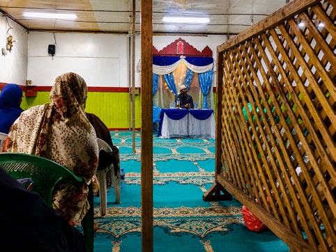 A gathering under a simple shelter